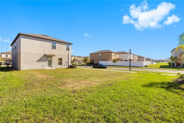 a living room with furniture a flat screen tv and a large window