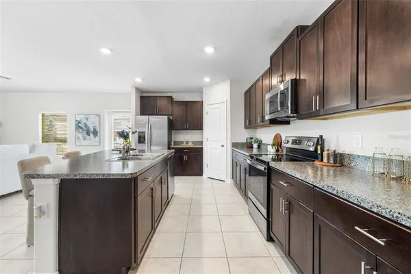 a view of a dining room with furniture and chandelier