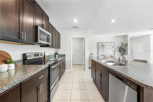 an empty room with windows and ceiling fan