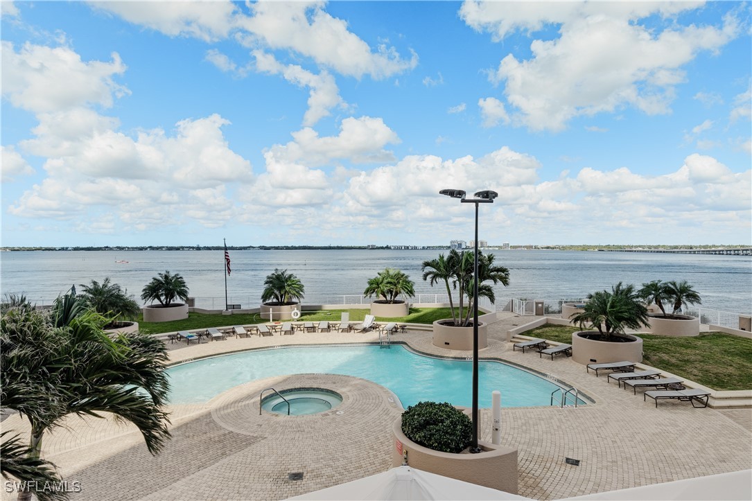 2090 West First Street, Unit I2409 Fort Myers, FL 33901 - Photo 36 of 50 a swimming pool with chairs