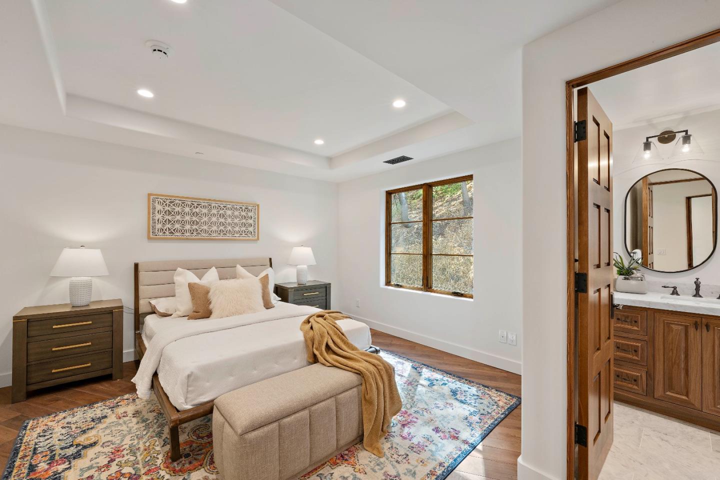 15269 Bohlman Road Saratoga, CA 95070 - Photo 37 of 68 a bedroom with a bed a mirror and next to a window