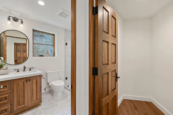 a bedroom with a bed and a mirror