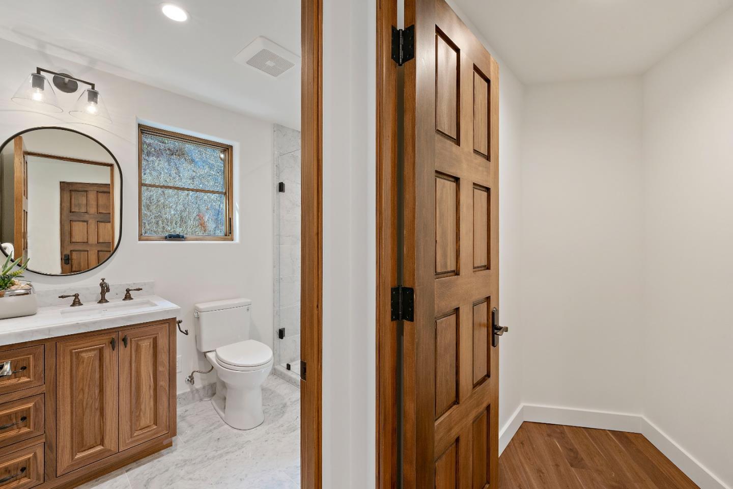 15269 Bohlman Road Saratoga, CA 95070 - Photo 39 of 68 a bathroom with a toilet sink a mirror and vanity