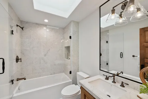 a bathroom with a double vanity sink a large mirror and shower