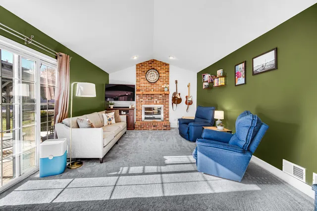 a living room with fireplace furniture and a flat screen tv