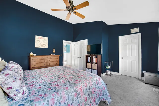 a bedroom with a bed and a television