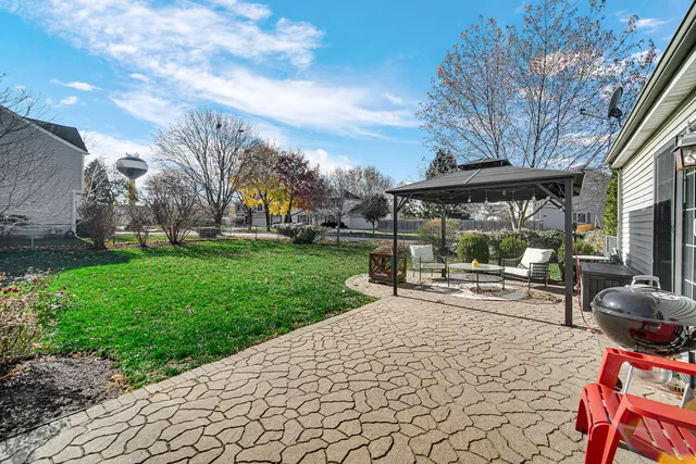 a view of a backyard with sitting area
