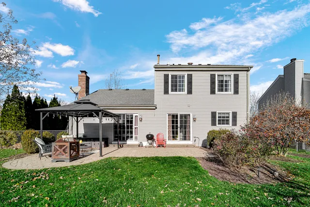 a view of a house with a backyard porch and sitting area