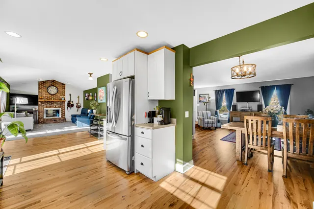 a view of a kitchen with furniture and wooden floor