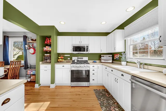 a kitchen with stainless steel appliances granite countertop a refrigerator and a stove top oven