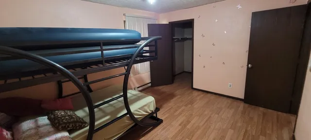 a view of room with wooden floor