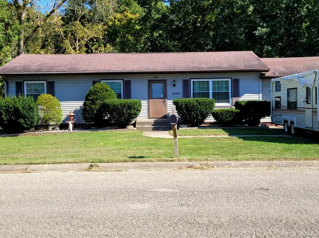 a view of a house with a yard and plants