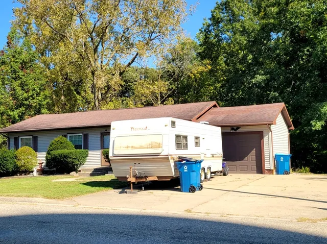 a view of a house with a patio and a yard