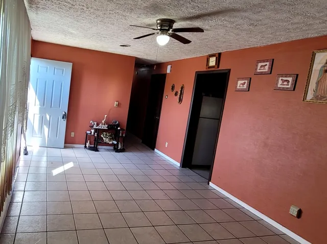 a view of a livingroom with a furniture and a ceiling fan