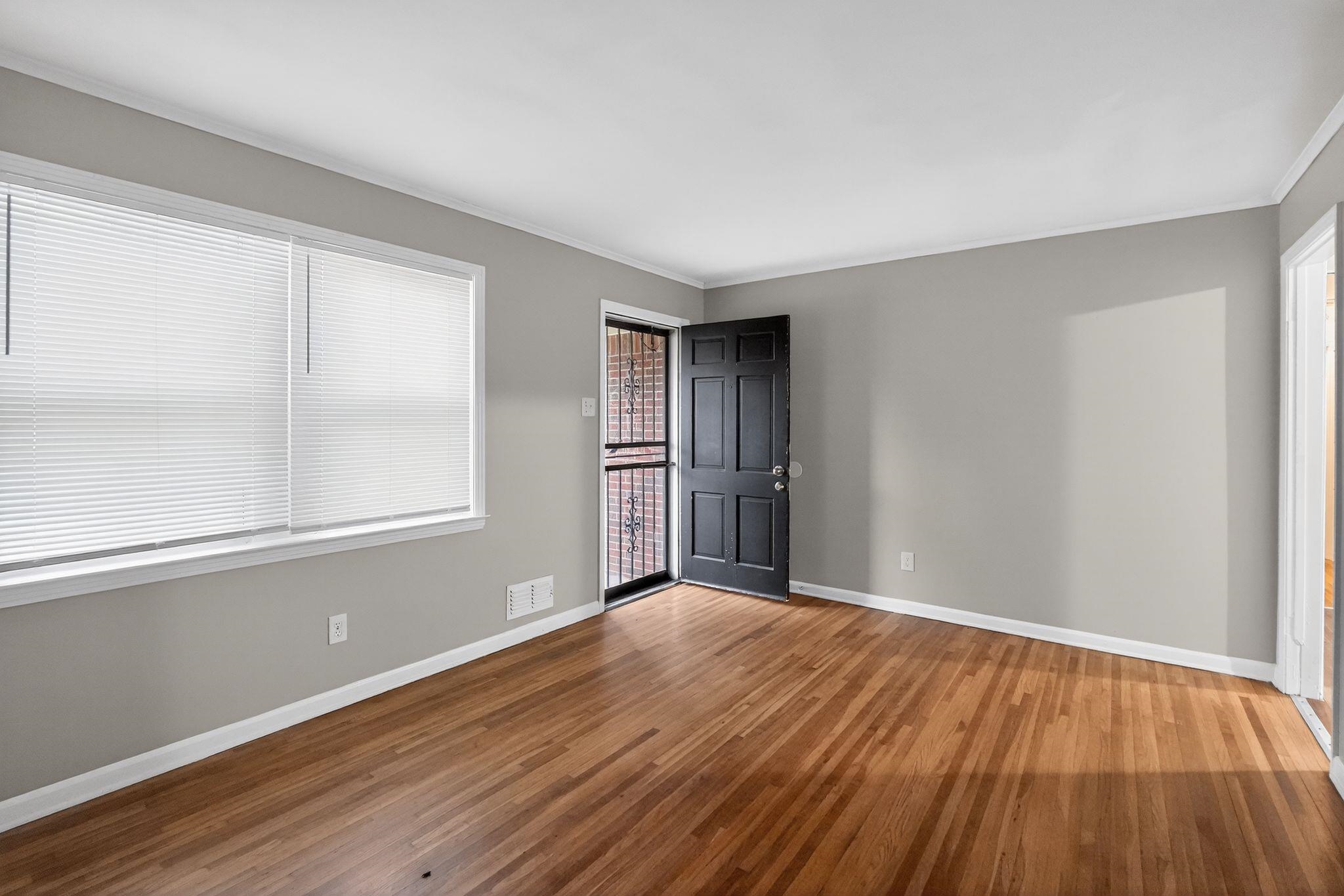 3150 Parham Street Memphis, TN 38127 - Photo 16 of 33 a view of an empty room with wooden floor and a window