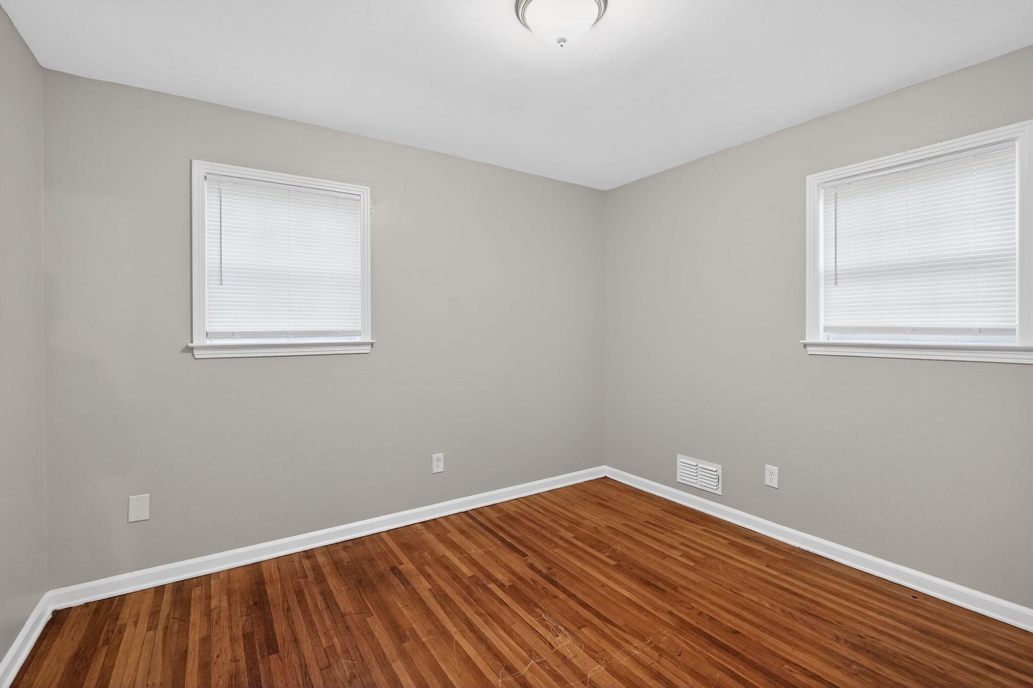 3150 Parham Street Memphis, TN 38127 - Photo 17 of 33 a view of an empty room with wooden floor and a window