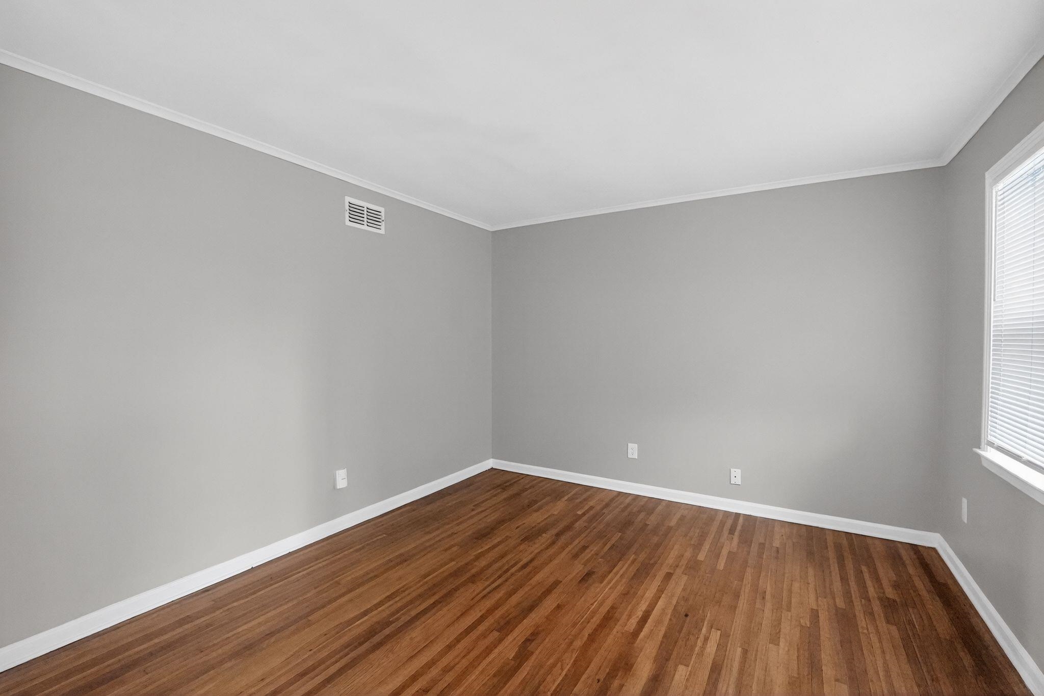 3150 Parham Street Memphis, TN 38127 - Photo 19 of 33 a view of an empty room with wooden floor and a window