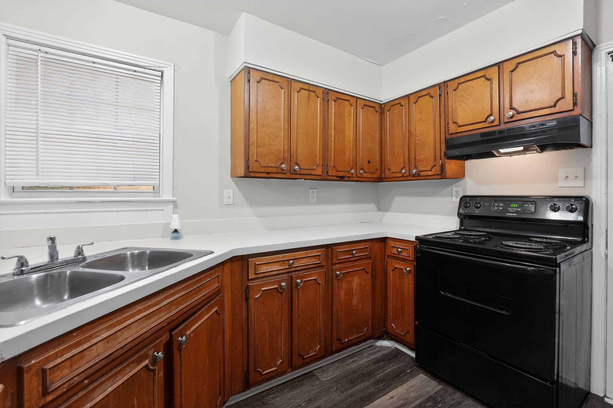 3150 Parham Street Memphis, TN 38127 - Photo 22 of 33 a kitchen with stainless steel appliances granite countertop a sink stove and cabinets