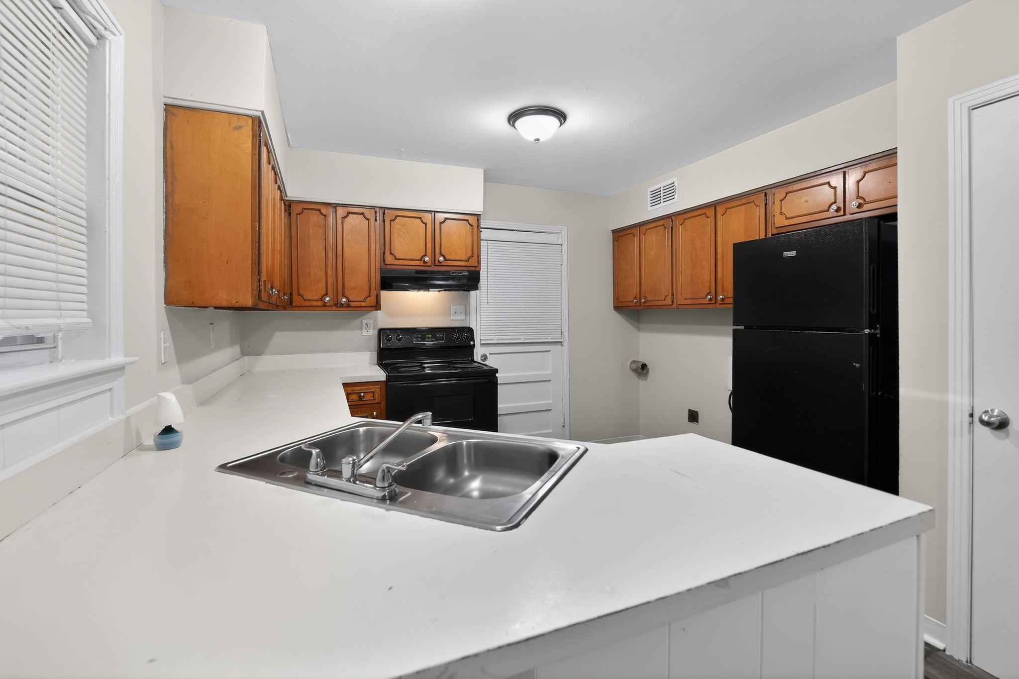 3150 Parham Street Memphis, TN 38127 - Photo 24 of 33 a kitchen with a refrigerator and a sink