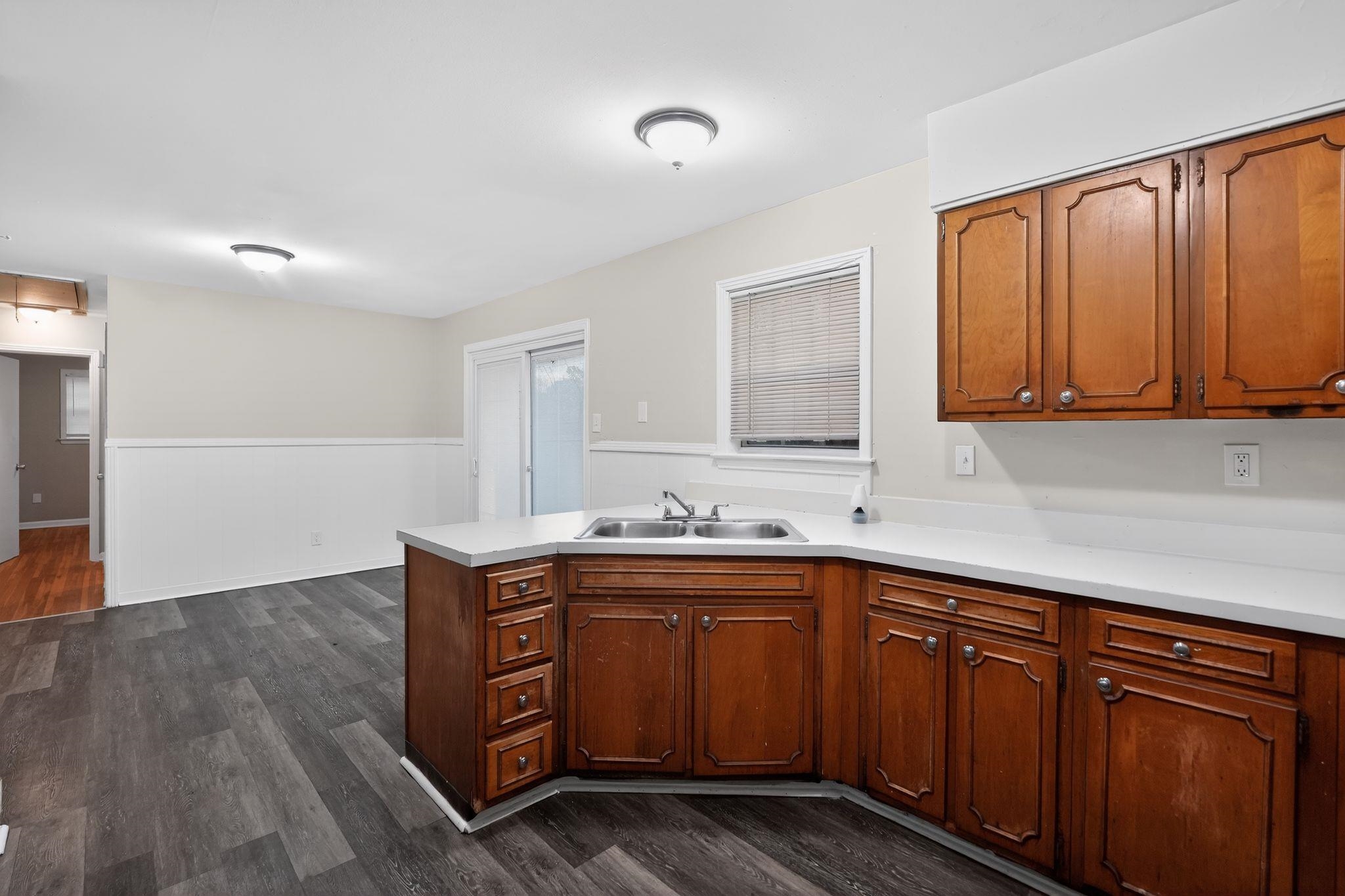 3150 Parham Street Memphis, TN 38127 - Photo 25 of 33 a kitchen with stainless steel appliances granite countertop wooden cabinets a sink and dishwasher