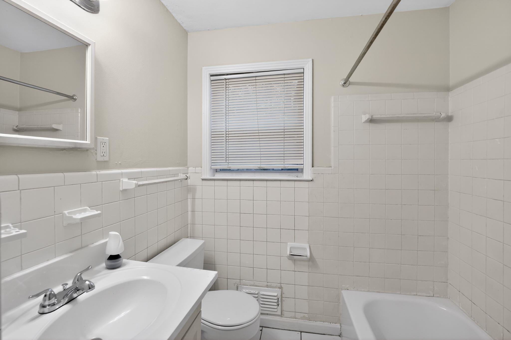 3150 Parham Street Memphis, TN 38127 - Photo 32 of 33 a bathroom with a sink a toilet and shower