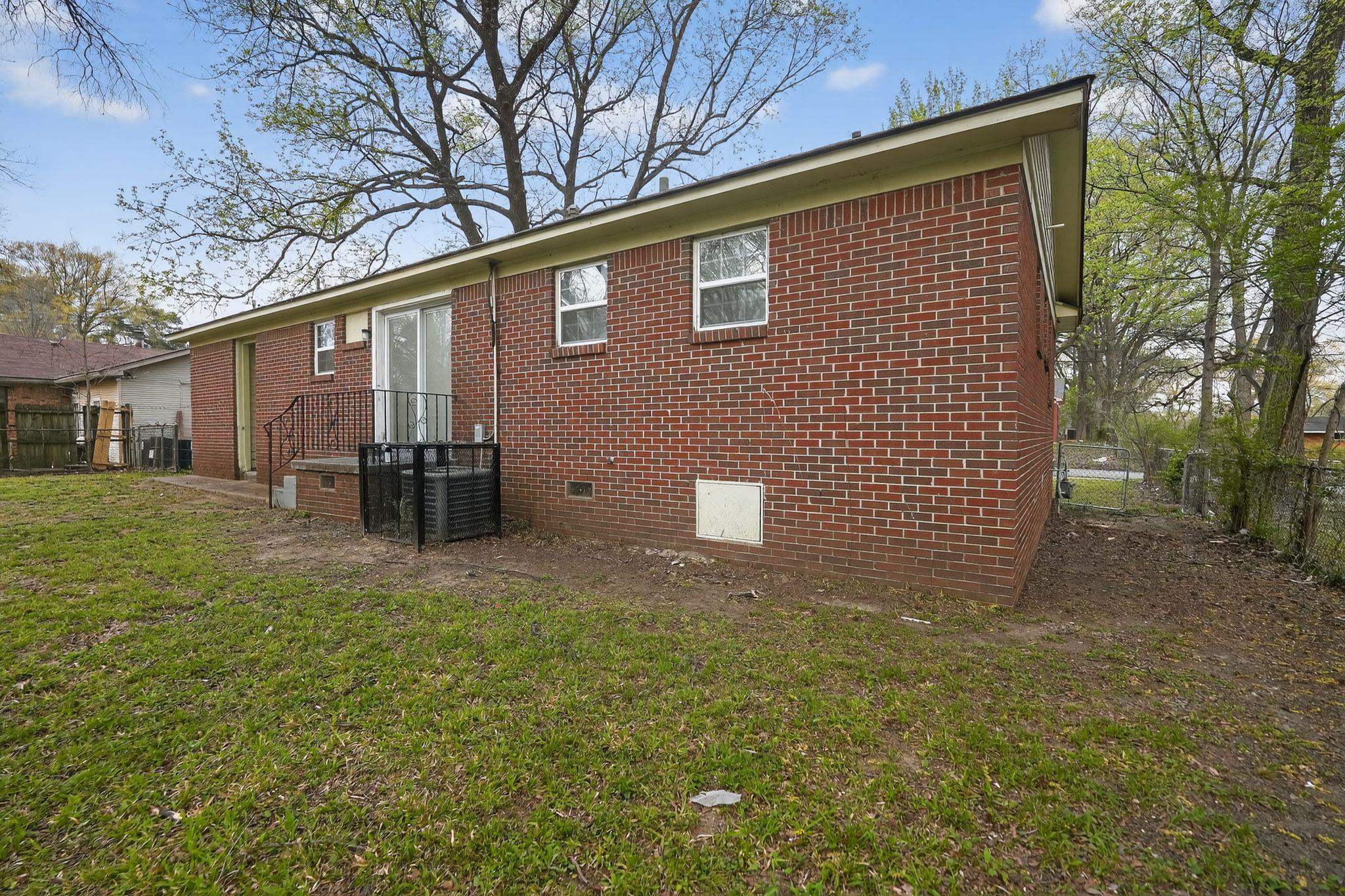 3150 Parham Street Memphis, TN 38127 - Photo 5 of 33 a backyard of a house with yard and outdoor seating