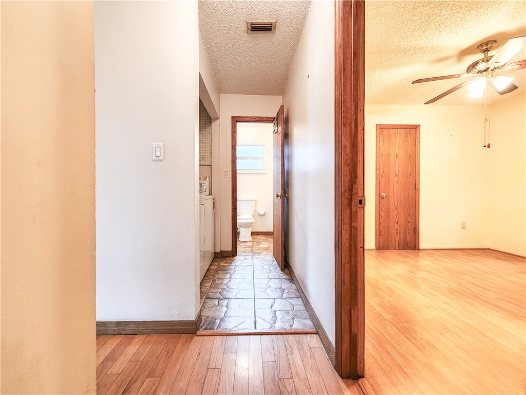 233 13th Street Southwest Vero Beach, FL 32962 - Photo 14 of 20 a view of a hallway with wooden floor and a bathroom