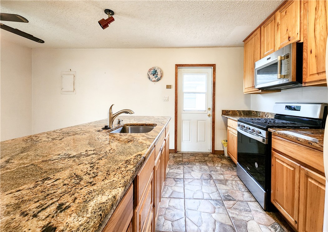 233 13th Street Southwest Vero Beach, FL 32962 - Photo 3 of 20 a kitchen with a stove a sink and a refrigerator