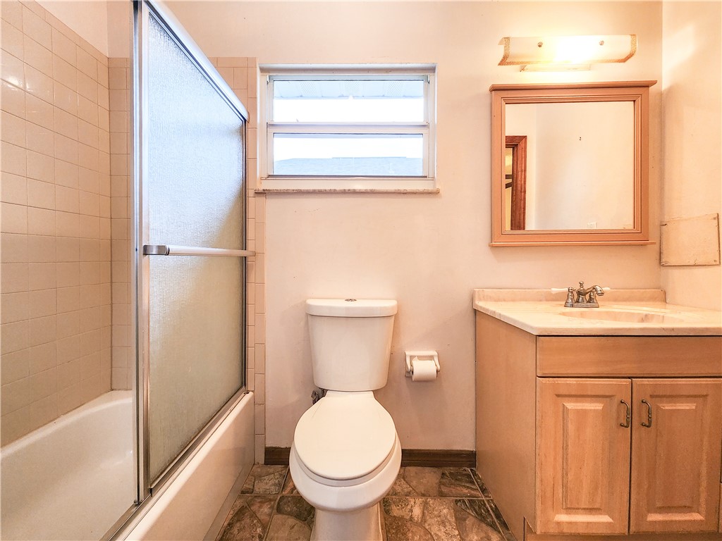 233 13th Street Southwest Vero Beach, FL 32962 - Photo 8 of 20 a bathroom with a toilet sink and a mirror