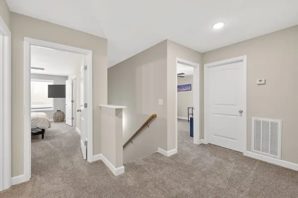a view of a hallway with a livingroom and a livingroom with furniture