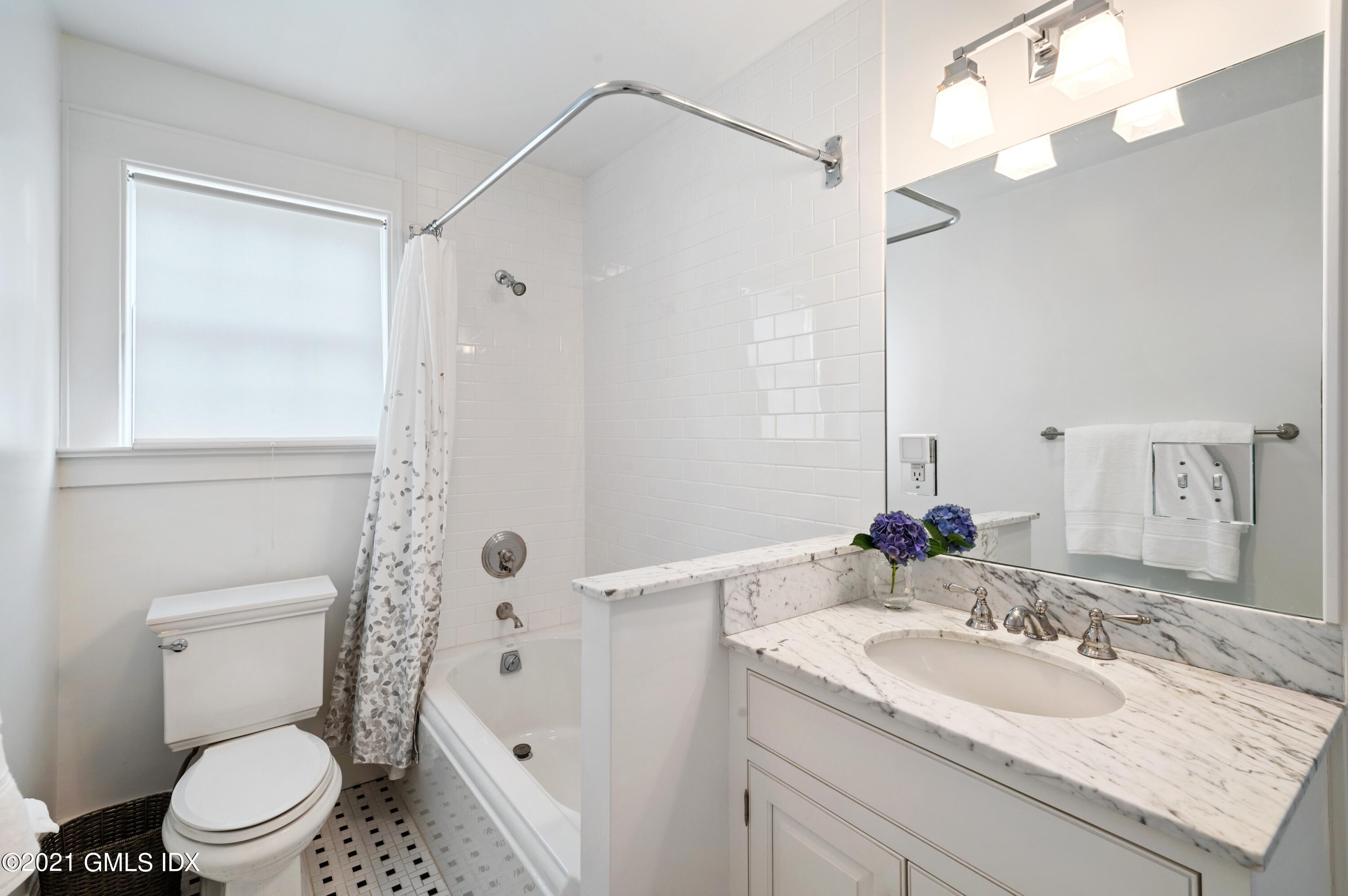 32 Perryridge Road Greenwich, CT 06830 - Photo 16 of 29 a bathroom with a granite countertop sink a toilet and a mirror