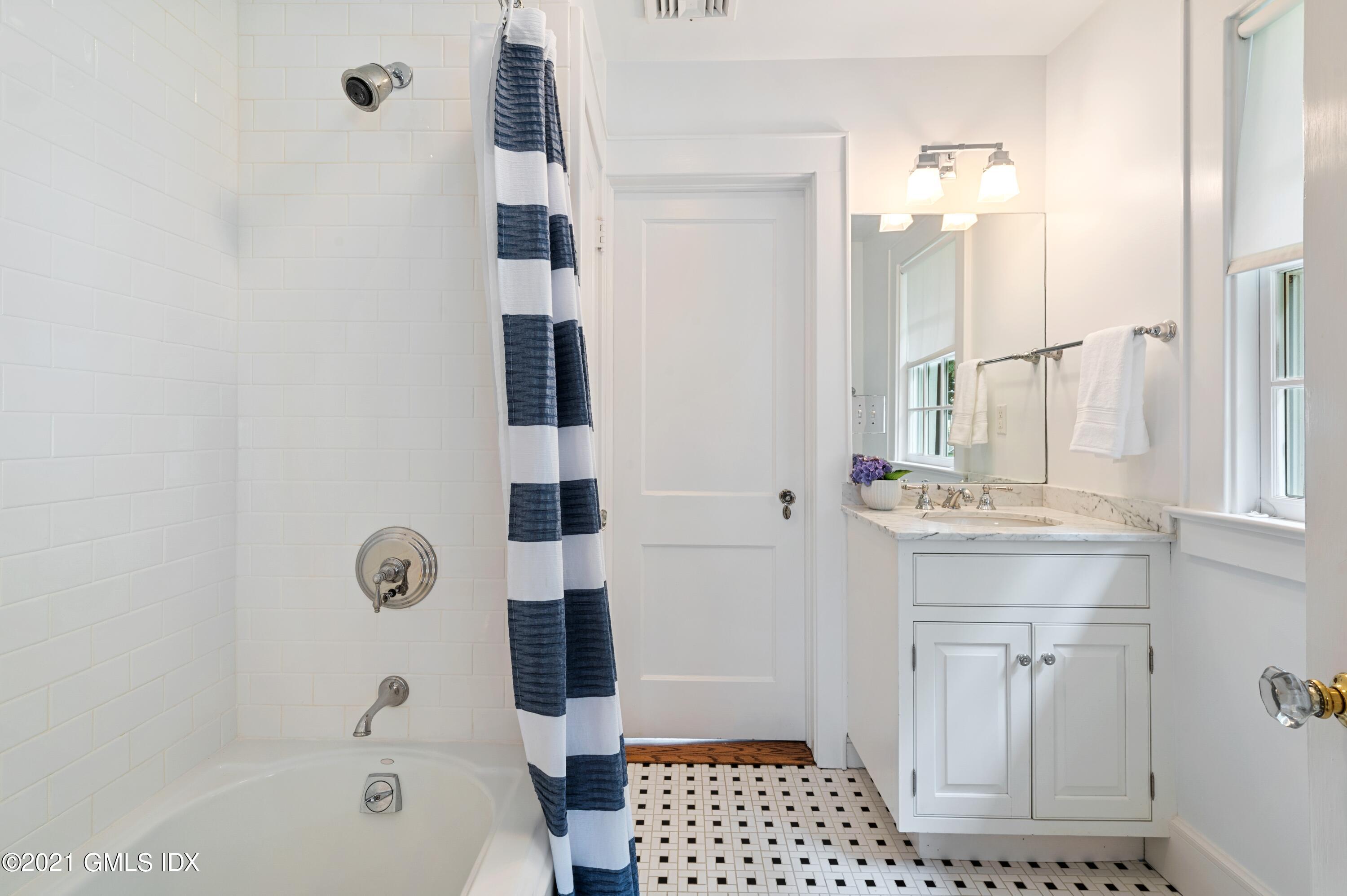 32 Perryridge Road Greenwich, CT 06830 - Photo 18 of 29 a bathroom with a sink a toilet a shower and a mirror