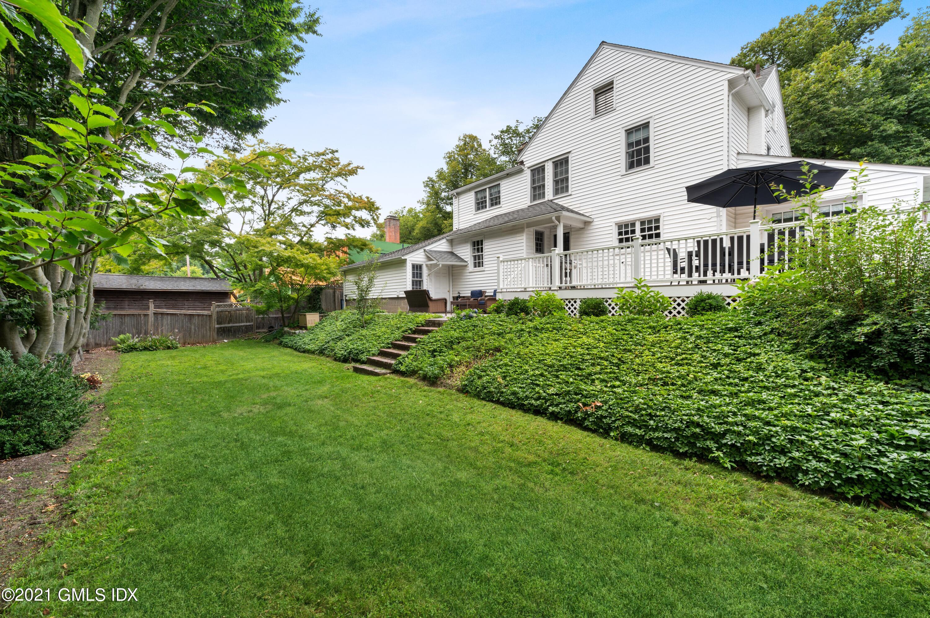 32 Perryridge Road Greenwich, CT 06830 - Photo 24 of 29 a front view of a house with a garden