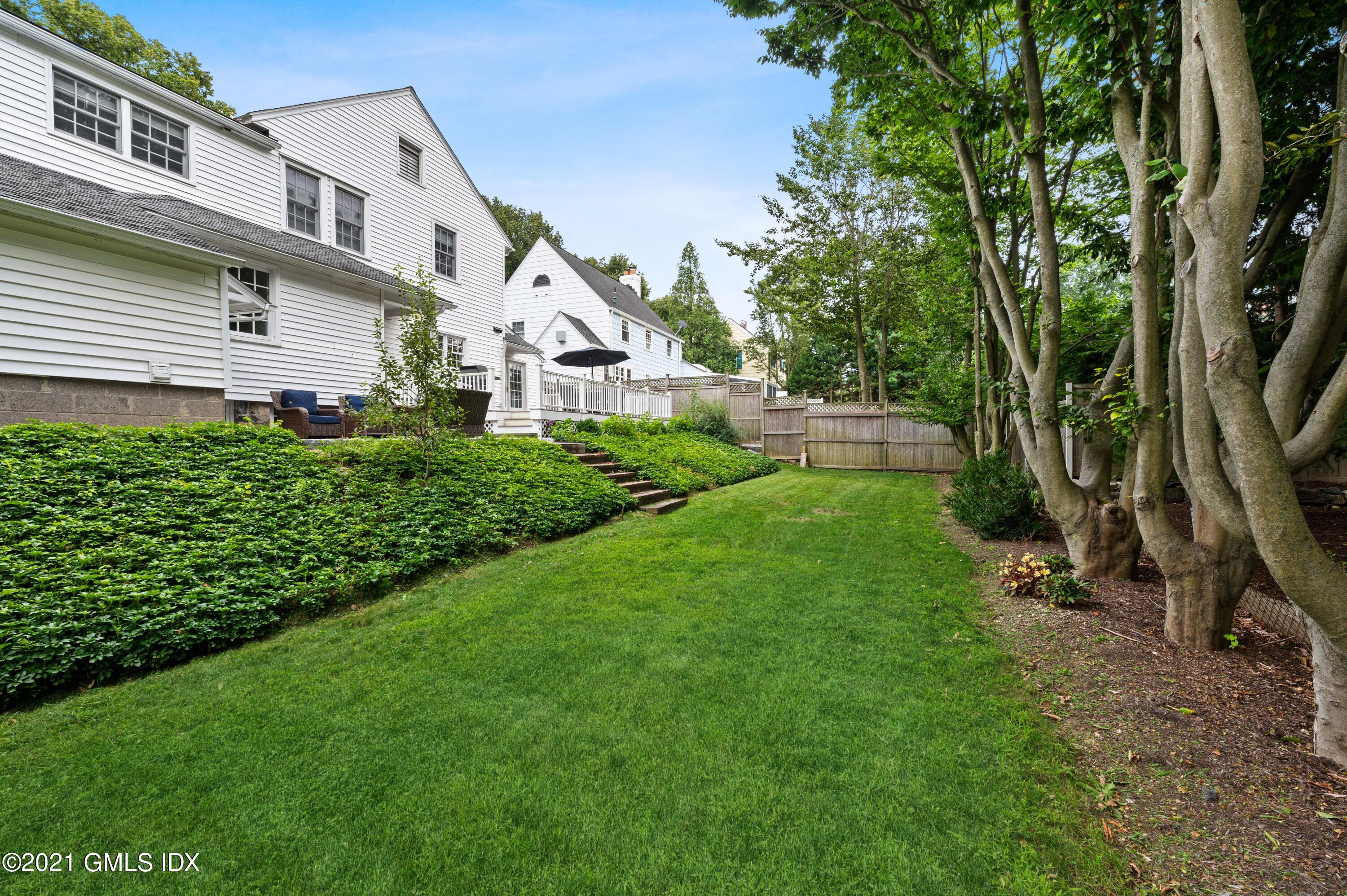 32 Perryridge Road Greenwich, CT 06830 - Photo 25 of 29 a front view of a house with a yard and trees