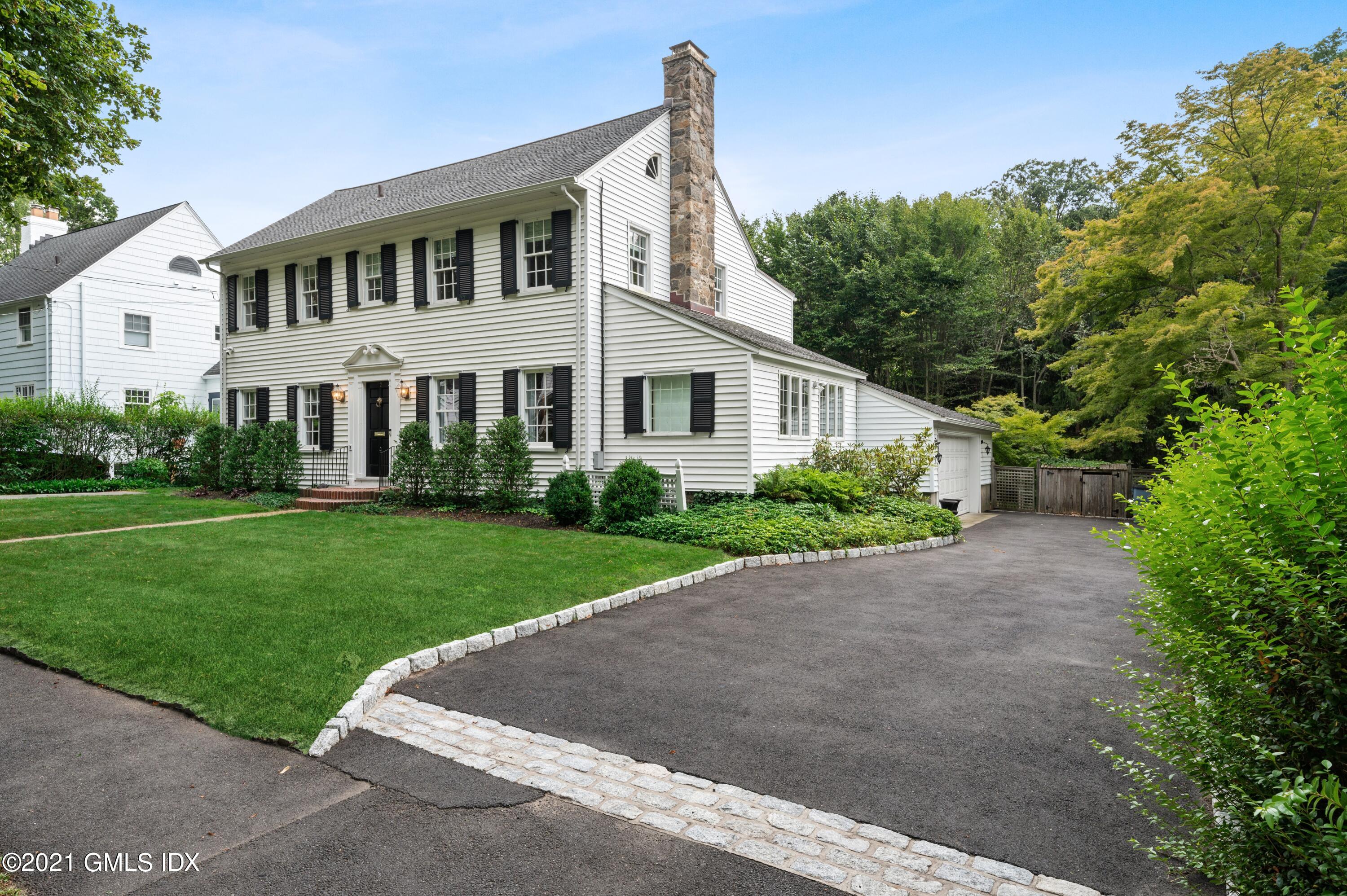 32 Perryridge Road Greenwich, CT 06830 - Photo 26 of 29 a front view of a house with a yard and garage