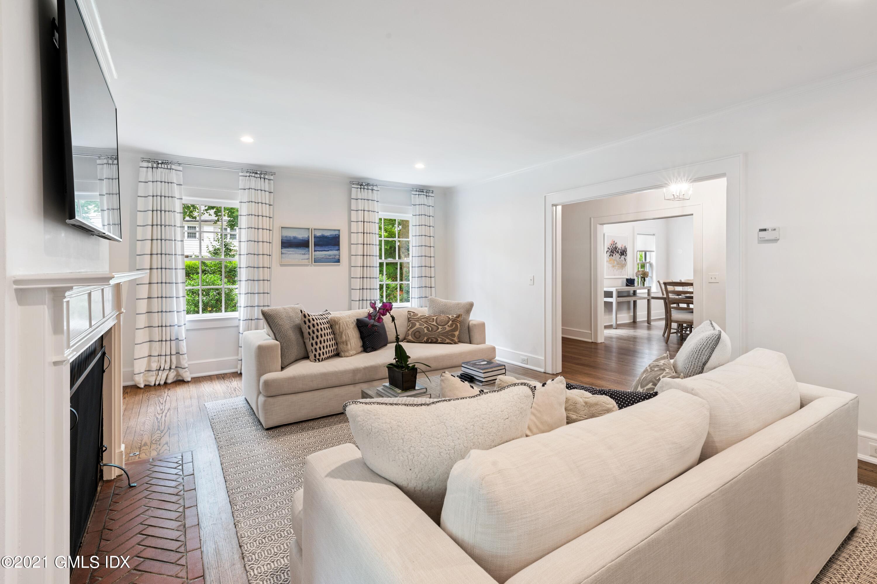 32 Perryridge Road Greenwich, CT 06830 - Photo 4 of 29 a living room with furniture flat screen tv and a fireplace