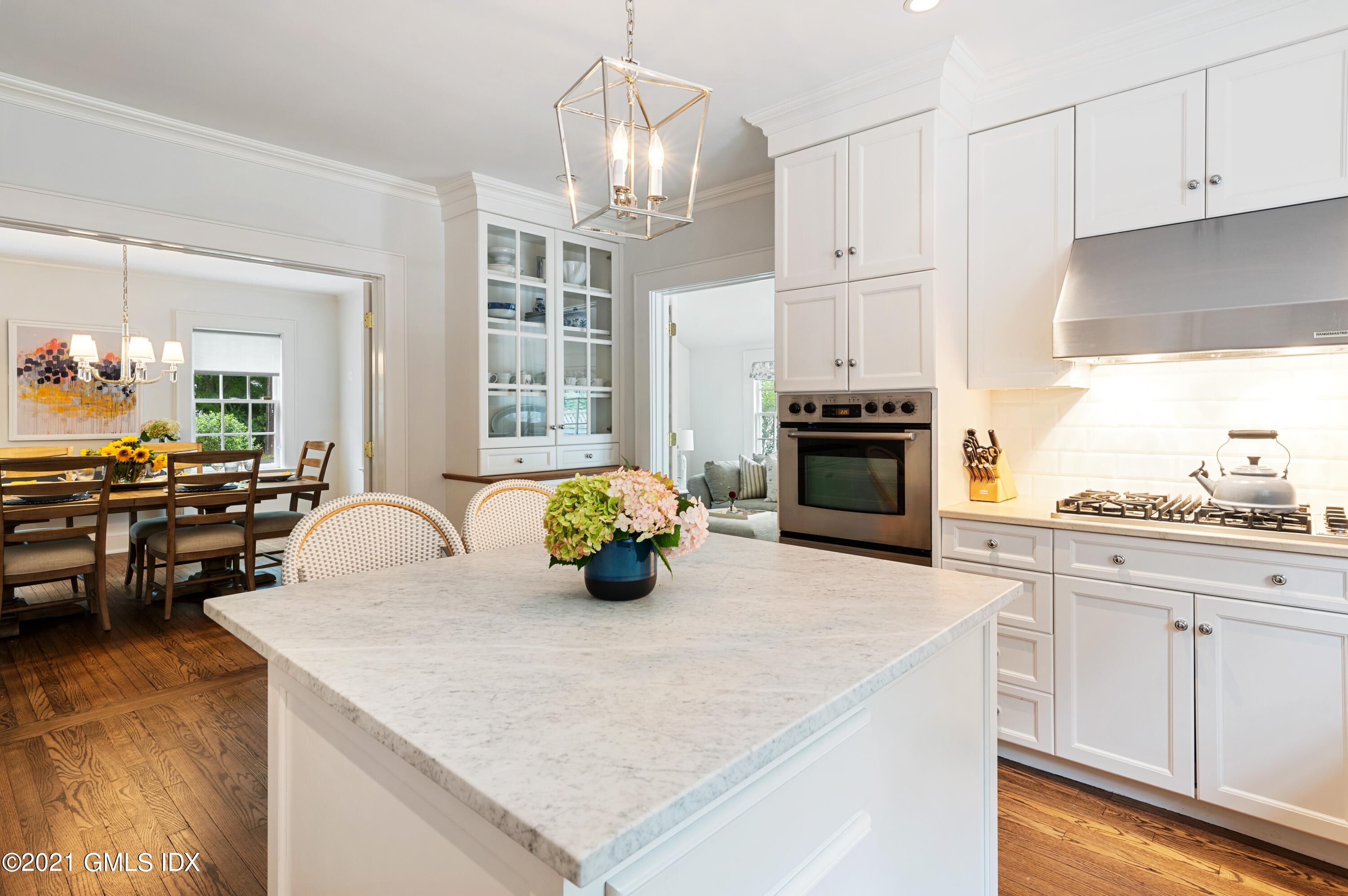 32 Perryridge Road Greenwich, CT 06830 - Photo 9 of 29 a kitchen with stainless steel appliances a stove a sink a center island and cabinets