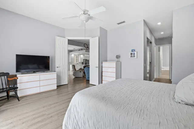 a bedroom with a bed and a flat screen tv