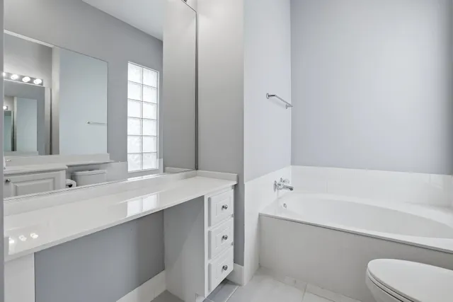 a bathroom with a tub sink and a mirror
