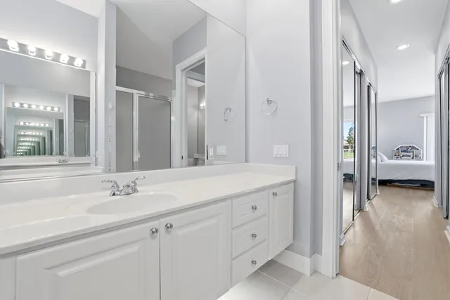 a en suite bathroom with a double sink and mirror