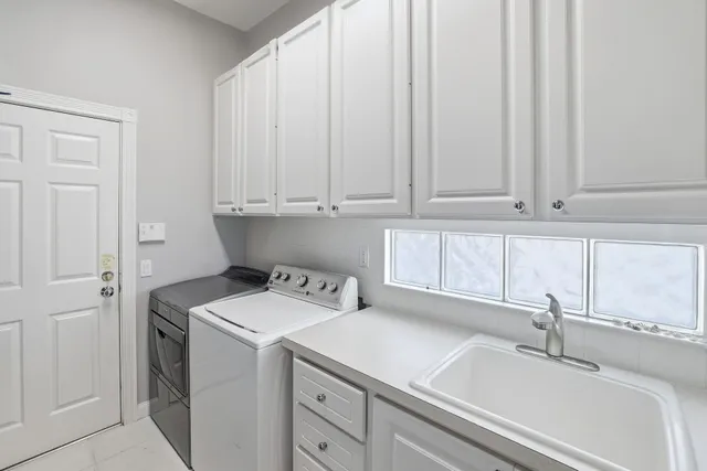 a utility room with a sink washer and dryer
