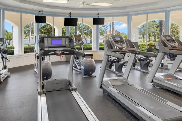 a view of a livingroom with furniture and floor to ceiling window
