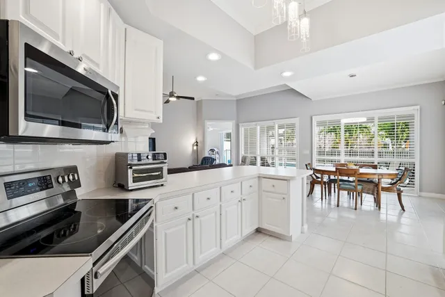 a kitchen with counter top space cabinets and appliances