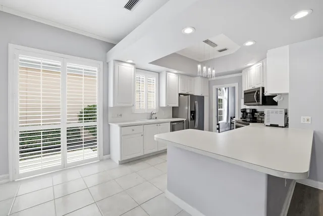 a kitchen with stainless steel appliances a refrigerator sink and cabinets