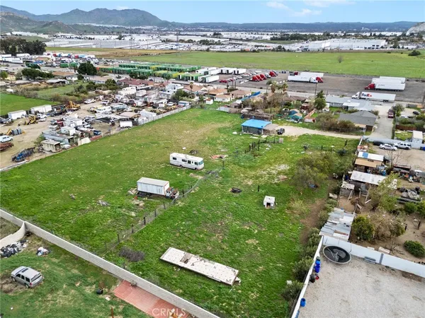 an aerial view of a residential houses with outdoor space