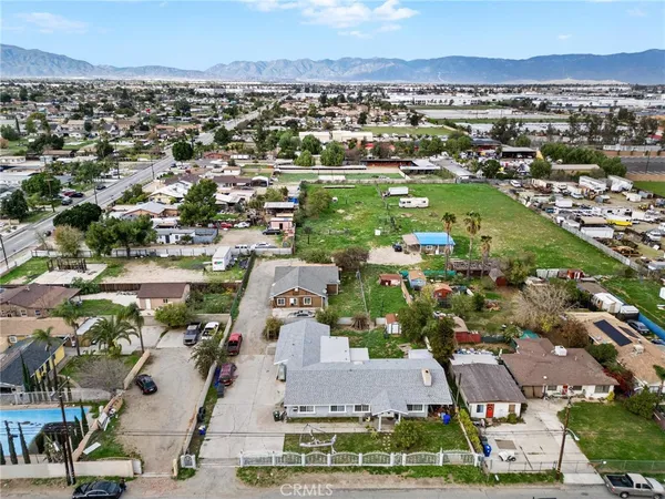 an aerial view of residential houses with outdoor space and street view