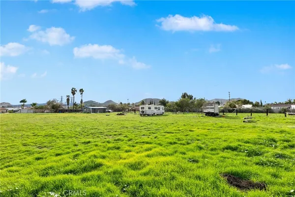 a car parked in the grass near a building