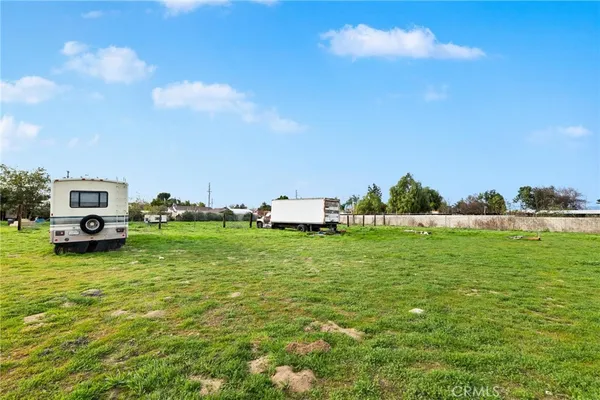 a view of a field of grass and trees