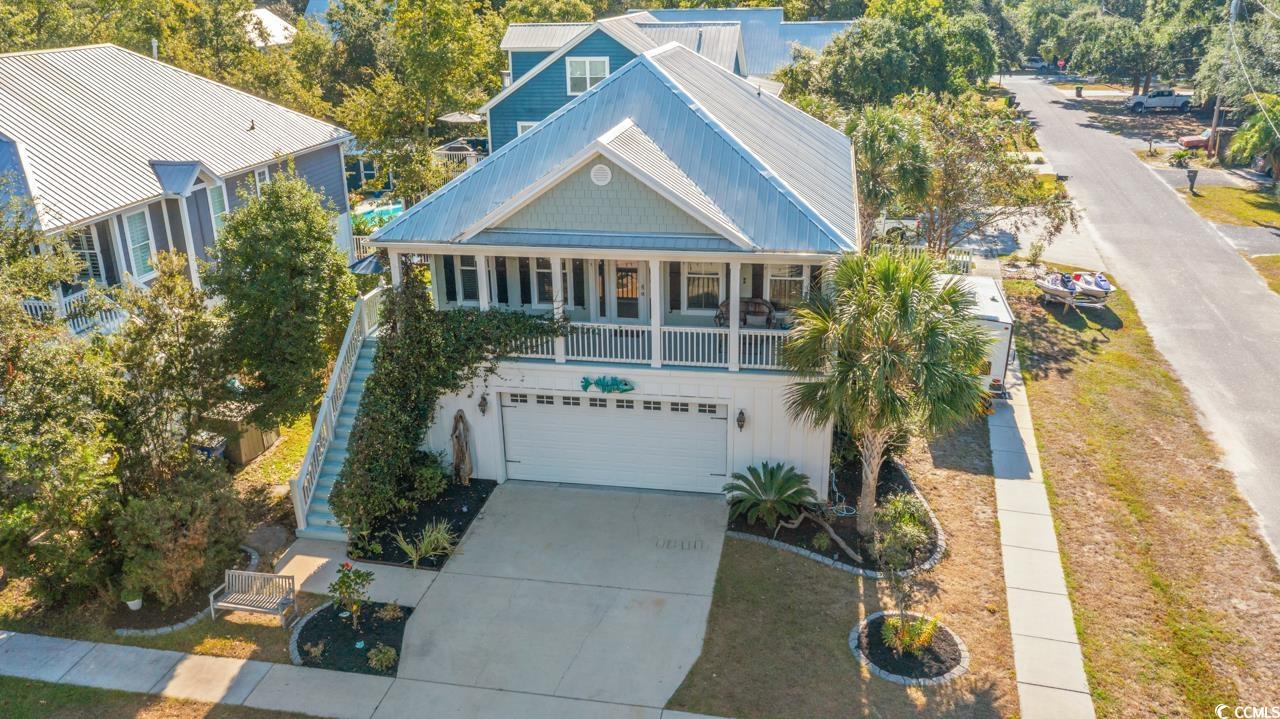 3887 Spanner Way Murrells Inlet, SC 29576 - Photo 1 of 32 View of front of home with a porch, concrete driveway, an attached garage, a metal roof, and stairs