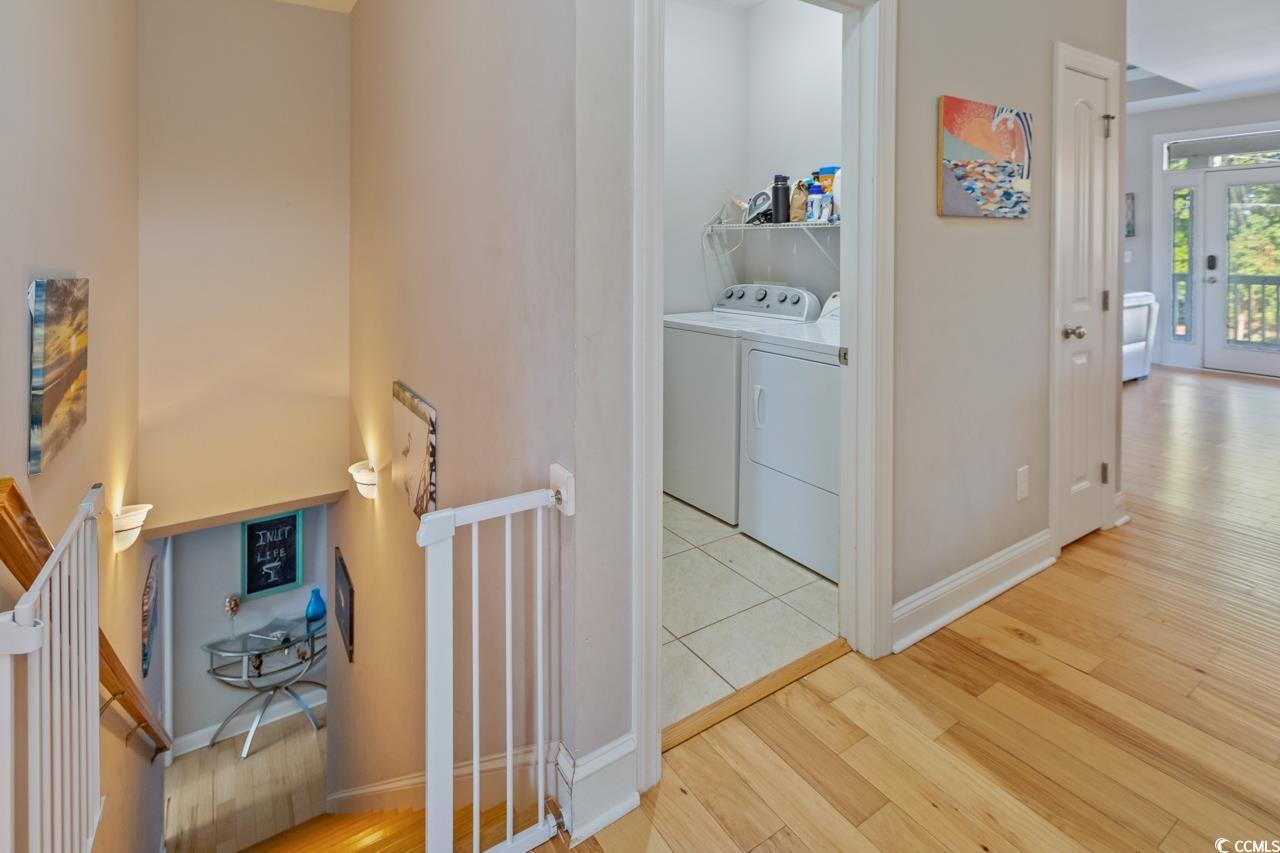 3887 Spanner Way Murrells Inlet, SC 29576 - Photo 13 of 32 Hallway featuring light wood finished floors and washing machine and clothes dryer